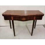 A large Inlaid Mahogany Foldover Card Table, with a serpentine front over tapered legs, with a green