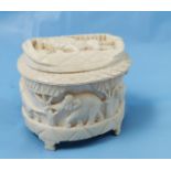 Small carved Ivory Trinket Box, decorated with Elephant reliefs and a lion on the lid, 8cmH x