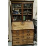 19thC Mahogany Bureau Bookcase, 2 bevelled glass doors enclosing book shelves, over a slopefront