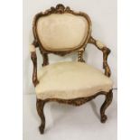 A French style carved giltwood open Armchair, with cream floral coloured seat and back