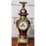 Red porcelain and fleur de lys design Mantle Clock, with a gilt Phoenix Mount, chimes on a bell, the