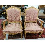 Matching Pair of carved Gilt Wood Framed Armchairs, the backs and seats covered with red and gold