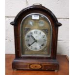 German Bracket Clock, the dial stamped YIWEICO, with a domed top and a brass carrying handle,