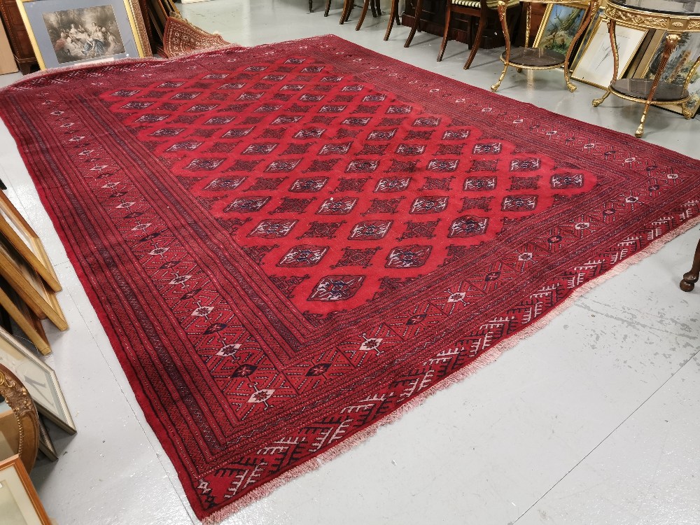 Large Handwoven Red Ground Iranian Carpet, with an all-over Bokhara Pattern, 3.8 x 3m