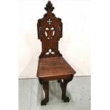 Oak Hall Chair, Gothic Design with a pierced back, on out-turned legs, supported on stretchers,
