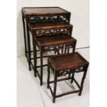 Nest of 4 Chinese graduating hardwood Tables with decorative floral fretwork, bamboo style legs,