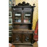 Tall Carved Oak 19thC Bookcase, crest style cornice mouldings over two glass doors supported on a
