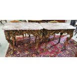 A matching Pair of curved Red Marble Topped Centre Tables, on decorative carved wood bases, each