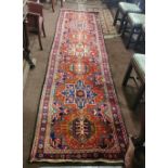 Large Iranian Runner, red ground with a beautiful floral star-burst medallion design, 4m x 1m