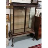 A Mahogany Display Cabinet, 1920’s, featuring 2 glass shelves, raised on ball and claw feet,