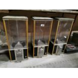 Three rare brass and chrome vending machine.