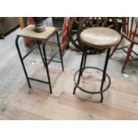 Two vintage metal and wooden stools.