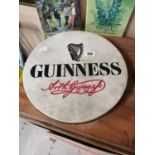 Bodhran decorated with Guinness advertising.