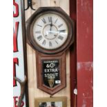 Early 20th C. mahogany regulator clock with later painted Guinness advertising.