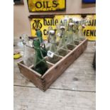 12 antique mineral bottles in crate.