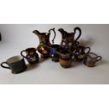 Eight pieces of Lustre ware - six jugs and two mugs.