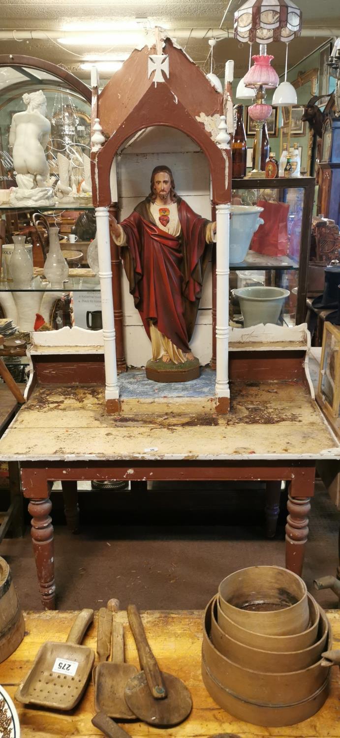 Pine altar stand with statue of Our Lord.