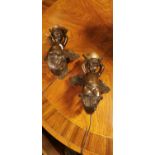 Pair of bronze cherub wall lights.