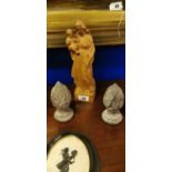 Pair of carved wooden finials and a carved figure.