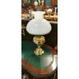 Brass table lamp with white mushroom shade.
