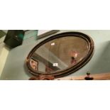 19th. C. ebonised and gilt oval mirror.