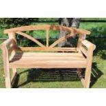 Arched teak two seater garden bench.
