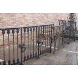 Curved black metal railing with brackets.