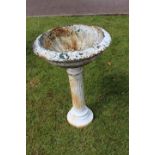 Cast iron garden urn on pedestal stand.