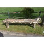 Large carved wooden garden bench.