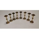 Set of eight early 20th C. brass candle sticks.
