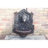 Decorative cast iron wall water fountain.