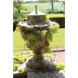 Pair of cast stone lidded urns.