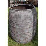 Ribbed metal water barrel.