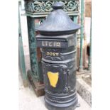 Black Irish circular post box.