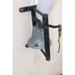 19th C. yard bell on cast iron wall bracket.