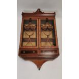 Mahogany and satinwood inlaid wall cabinet.