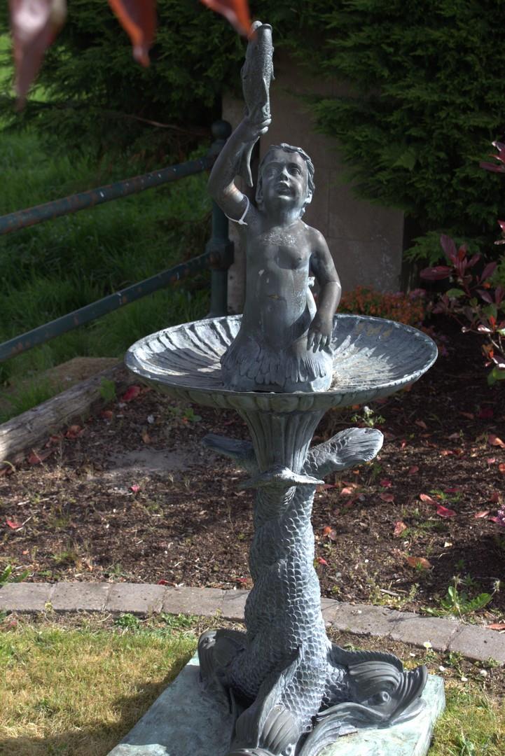 Bronze fountain in the form of a girl holding a fish.