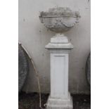 Composite white garden urn on stand.