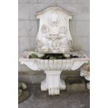 Decorative composition stone wall water fountain.