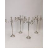 Set of four silver plate candelabras.