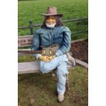 Seated figure of Willie Nelson.