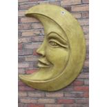 Aluminium wall plaque in the shape of a smiling half moon.