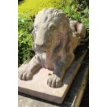 Cast stone model of seated a Lion.