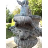 Pair of decorative bronze urns on stone plinths.