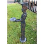 Cast iron candle holder in the form of a bell boy.
