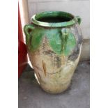 Green glazed stoneware water pot.