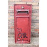 Cast aluminium panel of post box front.