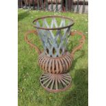 Metal open work garden planter with handles.