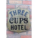 Three Cups Hotel brass advertising shield.