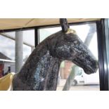 Mosaic black and gold model of a horse.